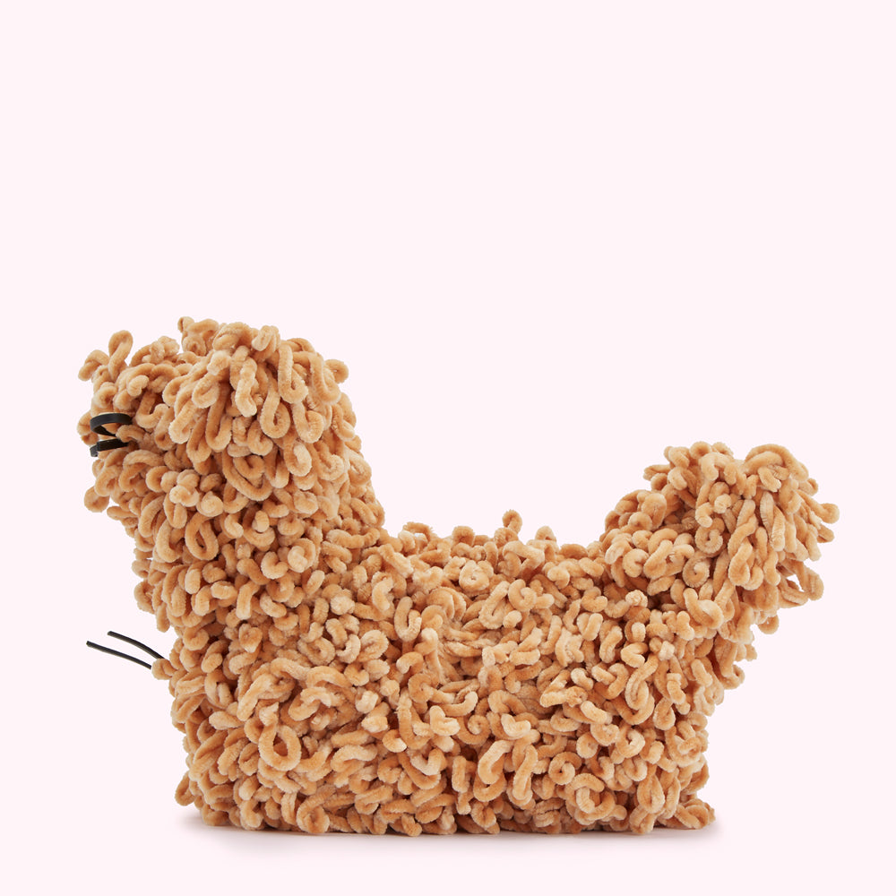 A tan, fluffy, abstract sculpture resembling a curled-up animal against a white background.
