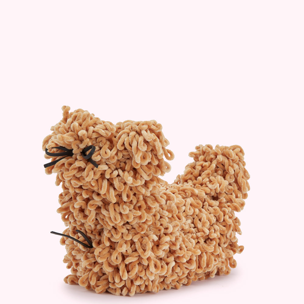 Tan coloured yarn dog figurine with black yarn bow.