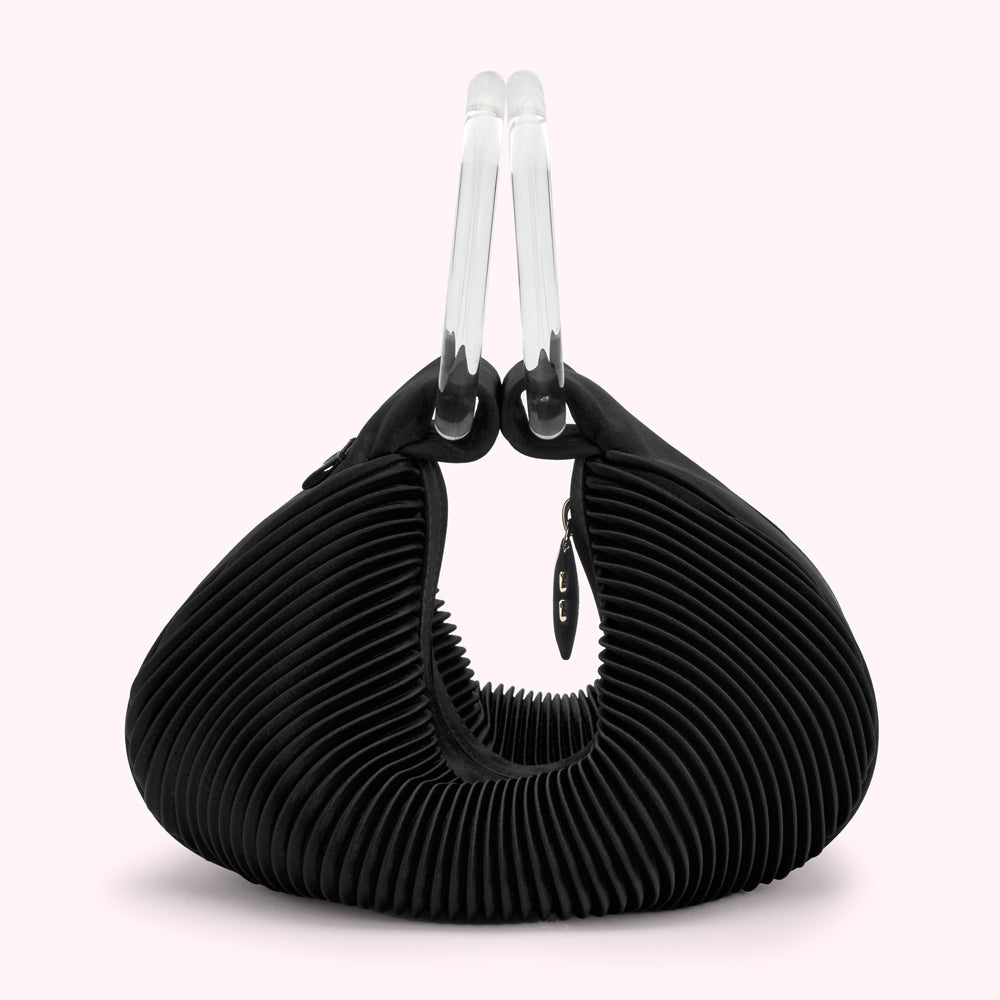 Black pleated handbag with clear acrylic handles.
