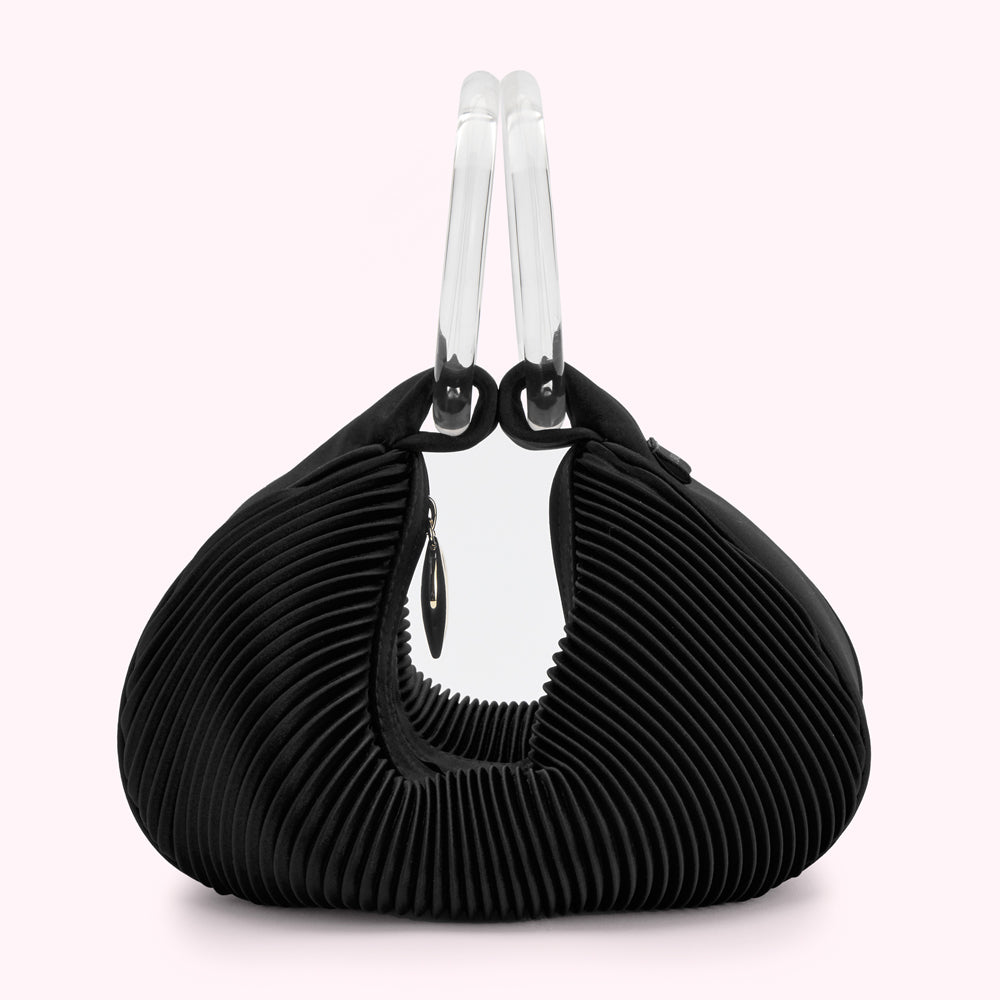 Black pleated handbag with clear acrylic handles.
