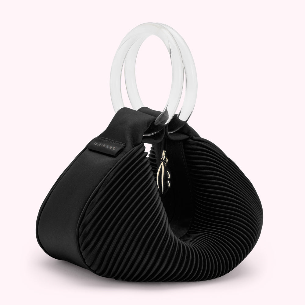 Black pleated satin Lulu Guinness handbag with clear acrylic top handle.
