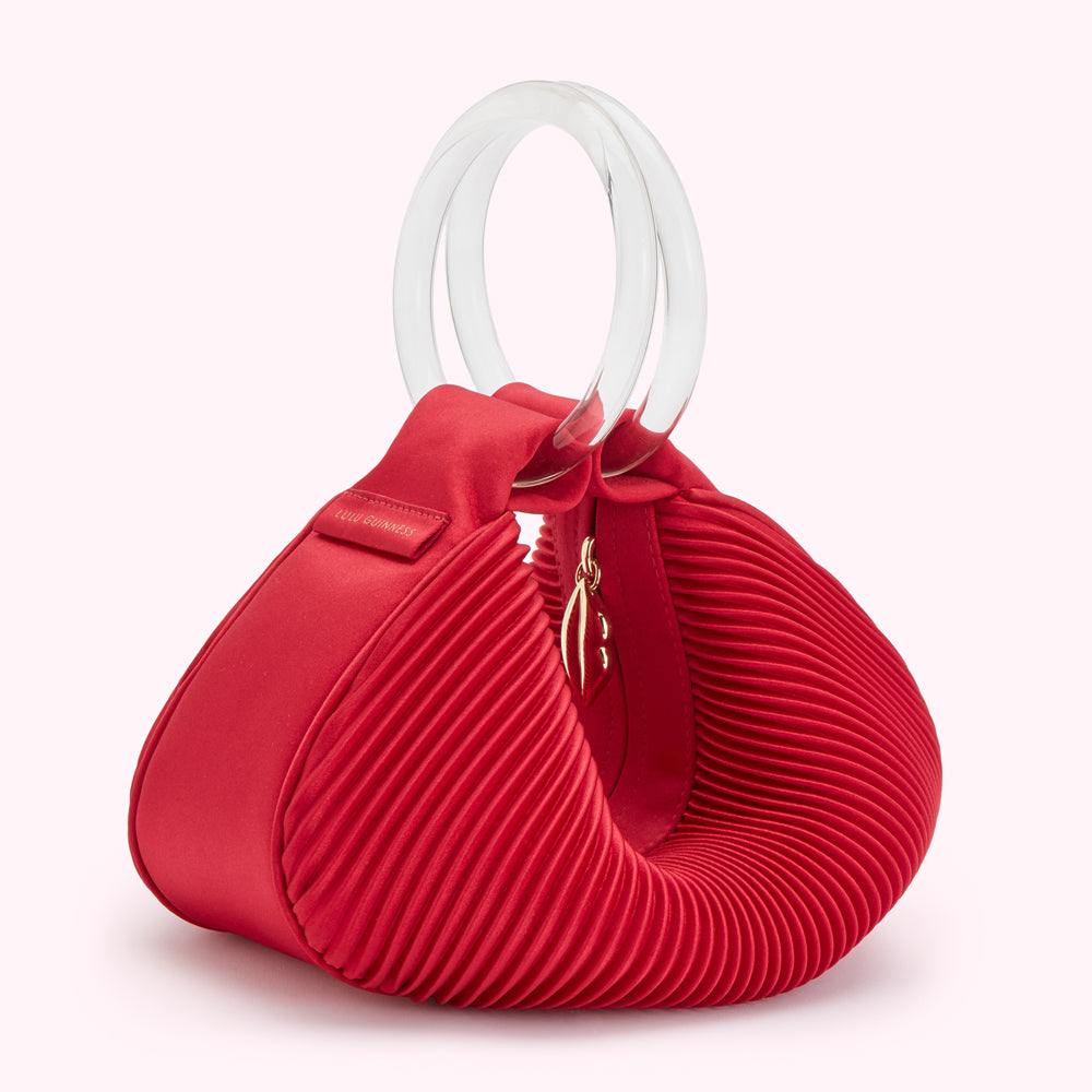 Red pleated satin Lulu Guinness handbag with clear Perspex handles.
