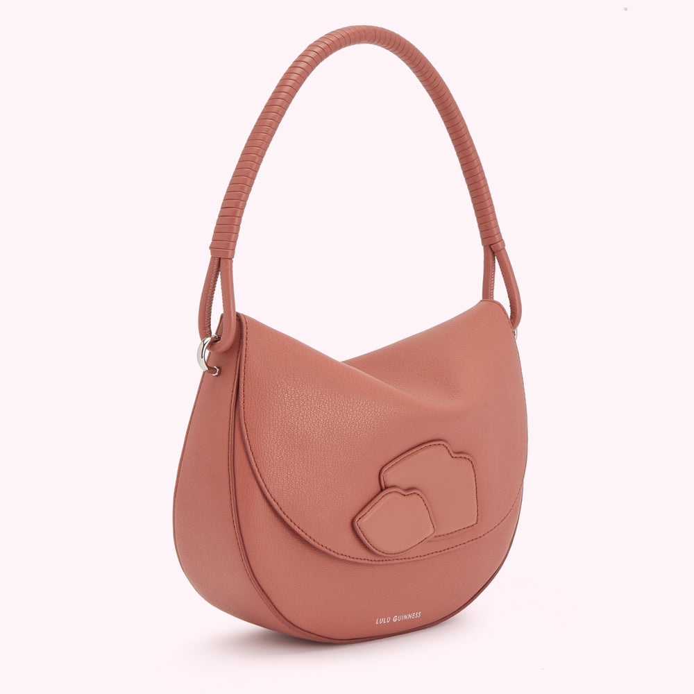 Dusty rose Lulu Guinness shoulder bag with a unique three-petal design.
