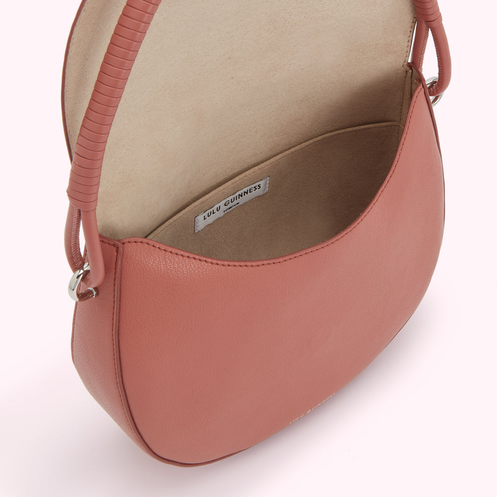 Dusty rose Lulu Guinness shoulder bag with beige interior and a braided handle.
