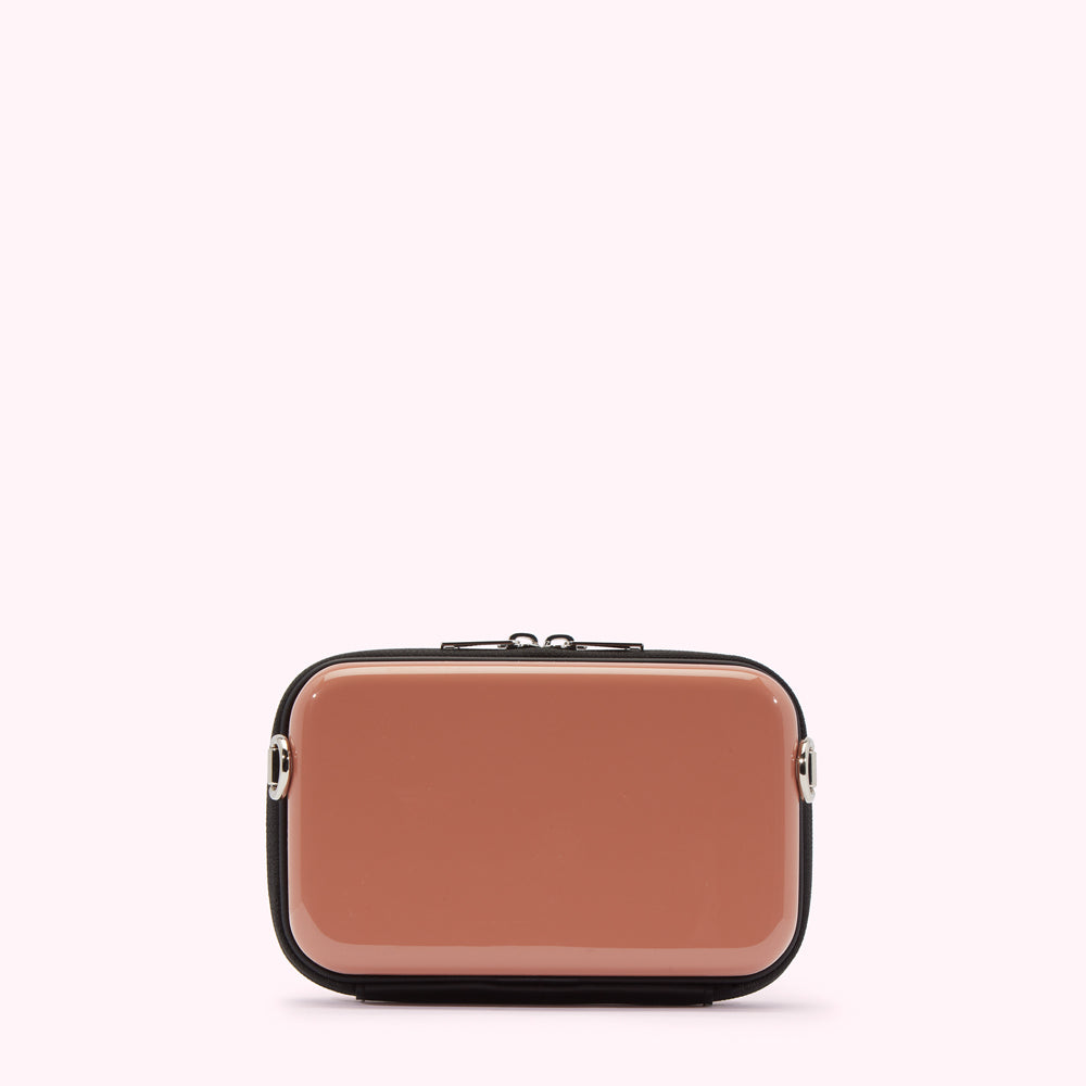 A dusty rose rectangular crossbody bag with black trim and silver hardware against a white background.
