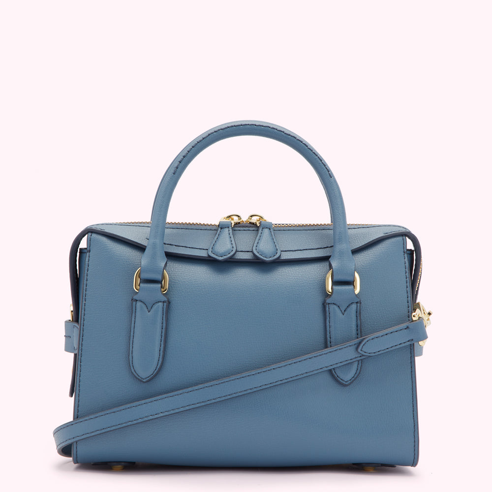 Dusty blue leather handbag with gold-tone hardware and a detachable shoulder strap.
