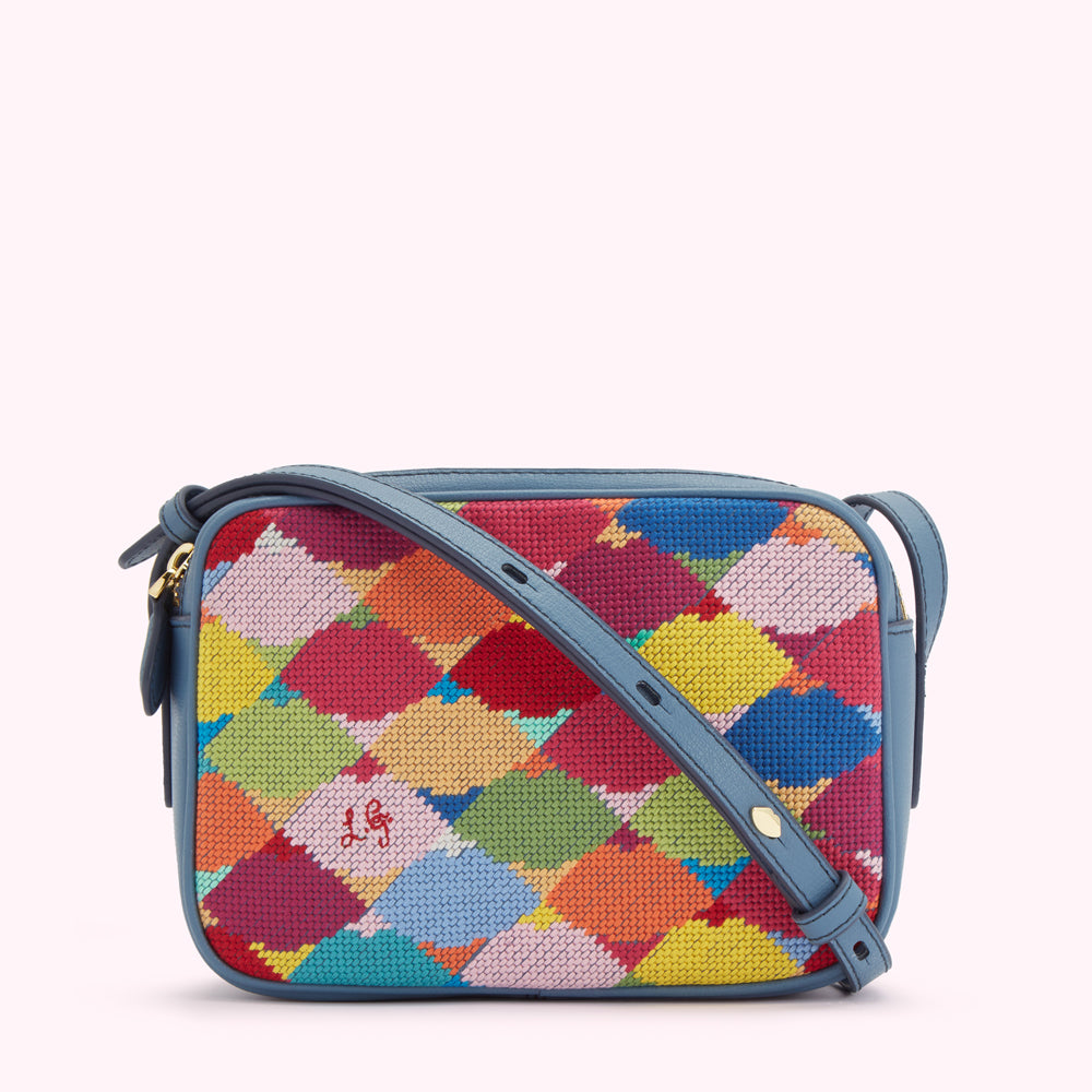 A small, rectangular crossbody bag with a blue leather strap and a colourful needlepoint front.