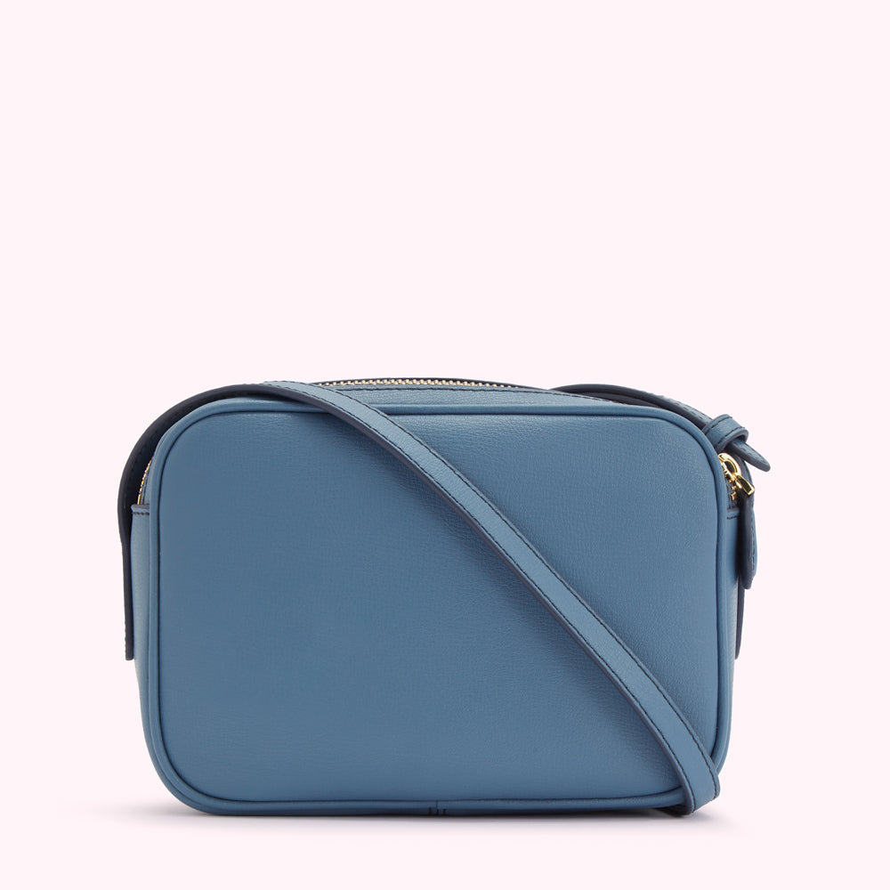 A blue leather crossbody bag with a gold zipper.
