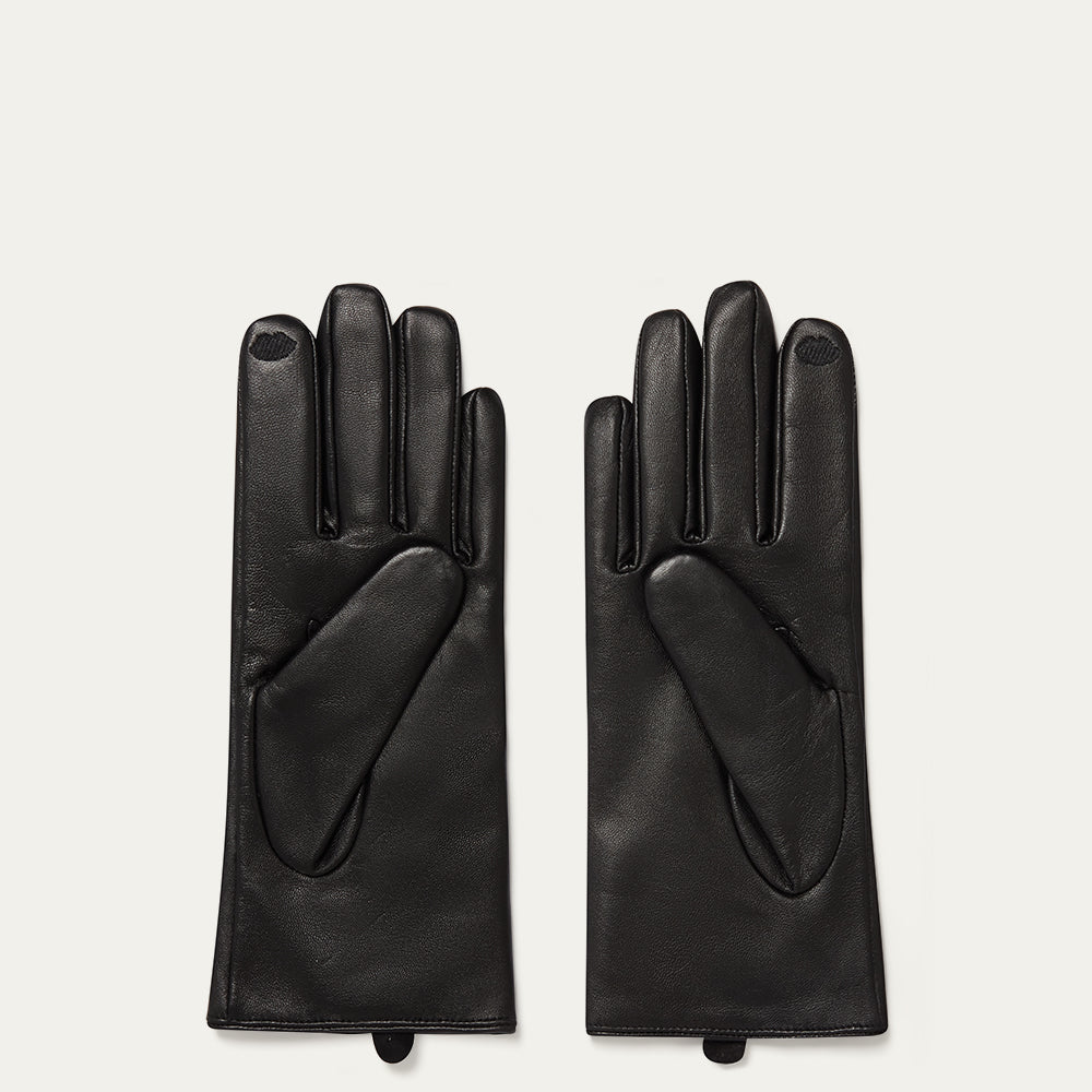 Pair of black leather gloves on a light gray background