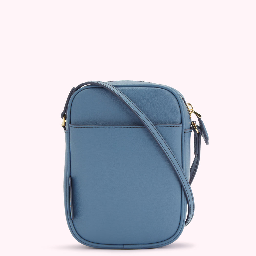 A blue crossbody bag with a gold zipper and strap.
