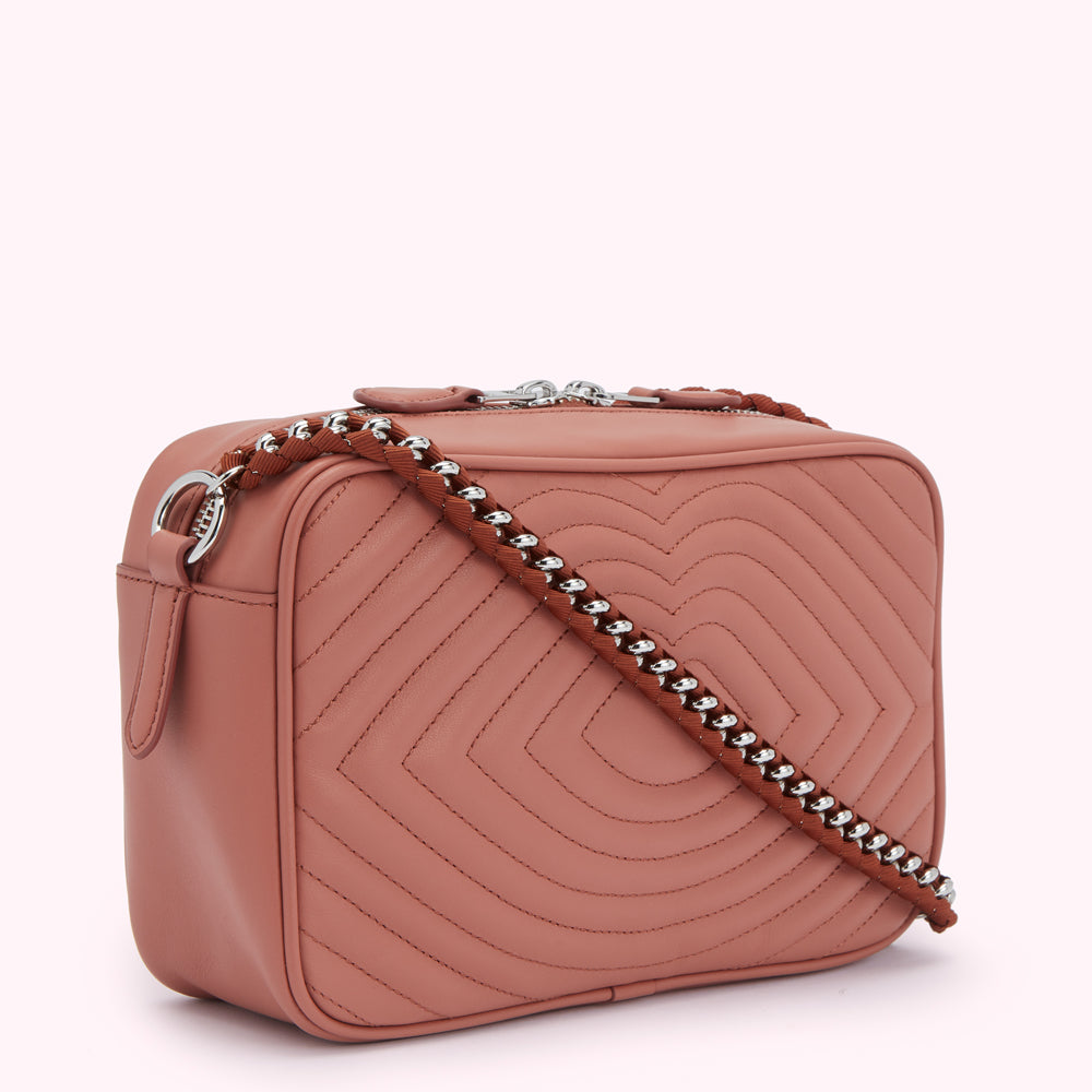 Dusty rose quilted leather crossbody bag with a chain and fabric strap.

