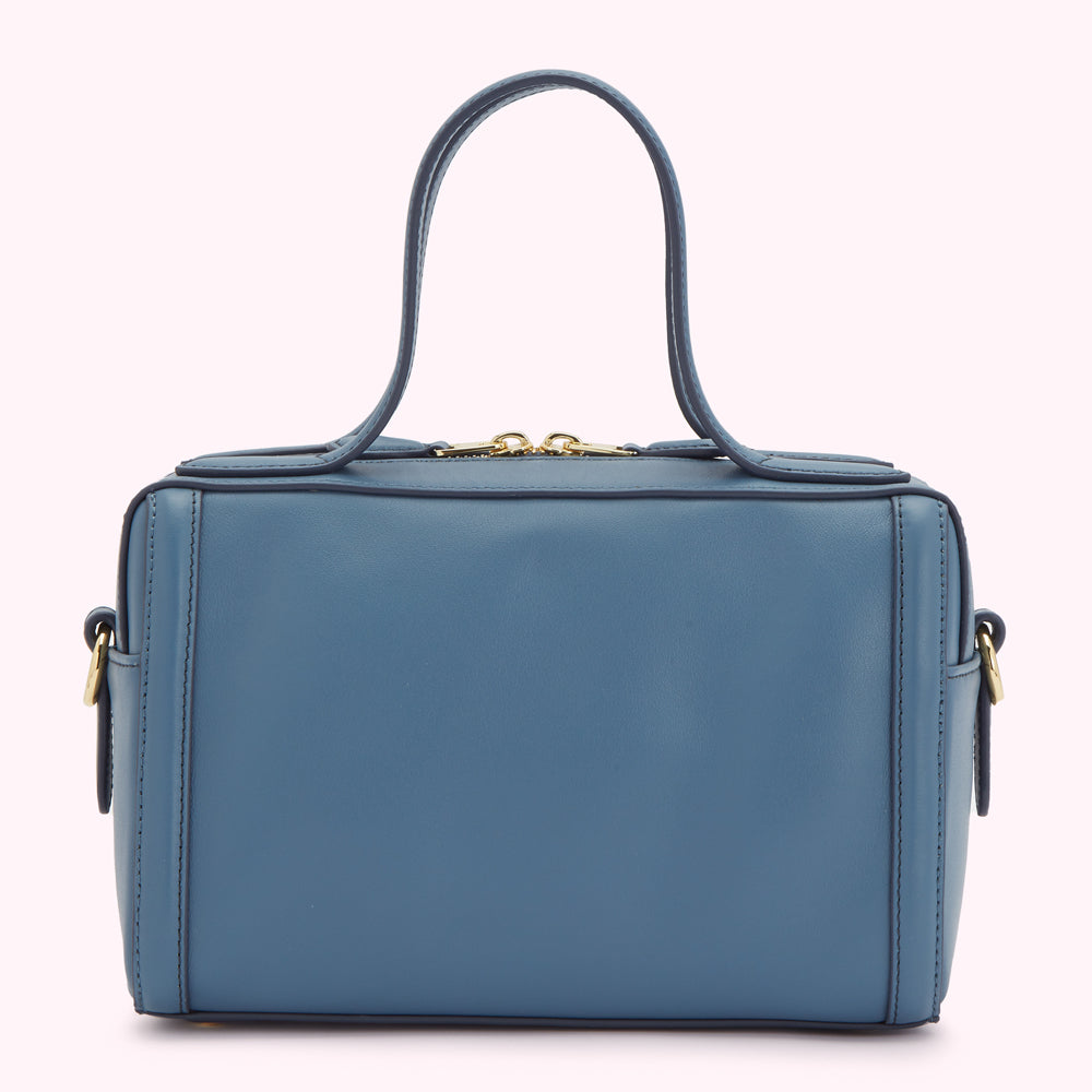A steel blue leather handbag with top handles and a zip closure.

