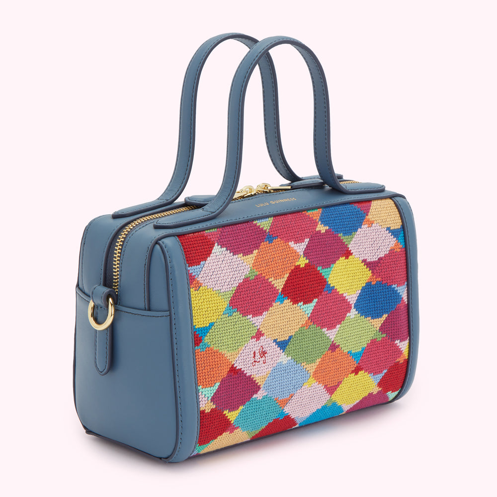 A teal blue Lulu Guinness handbag with a multi-coloured needlepoint panel.