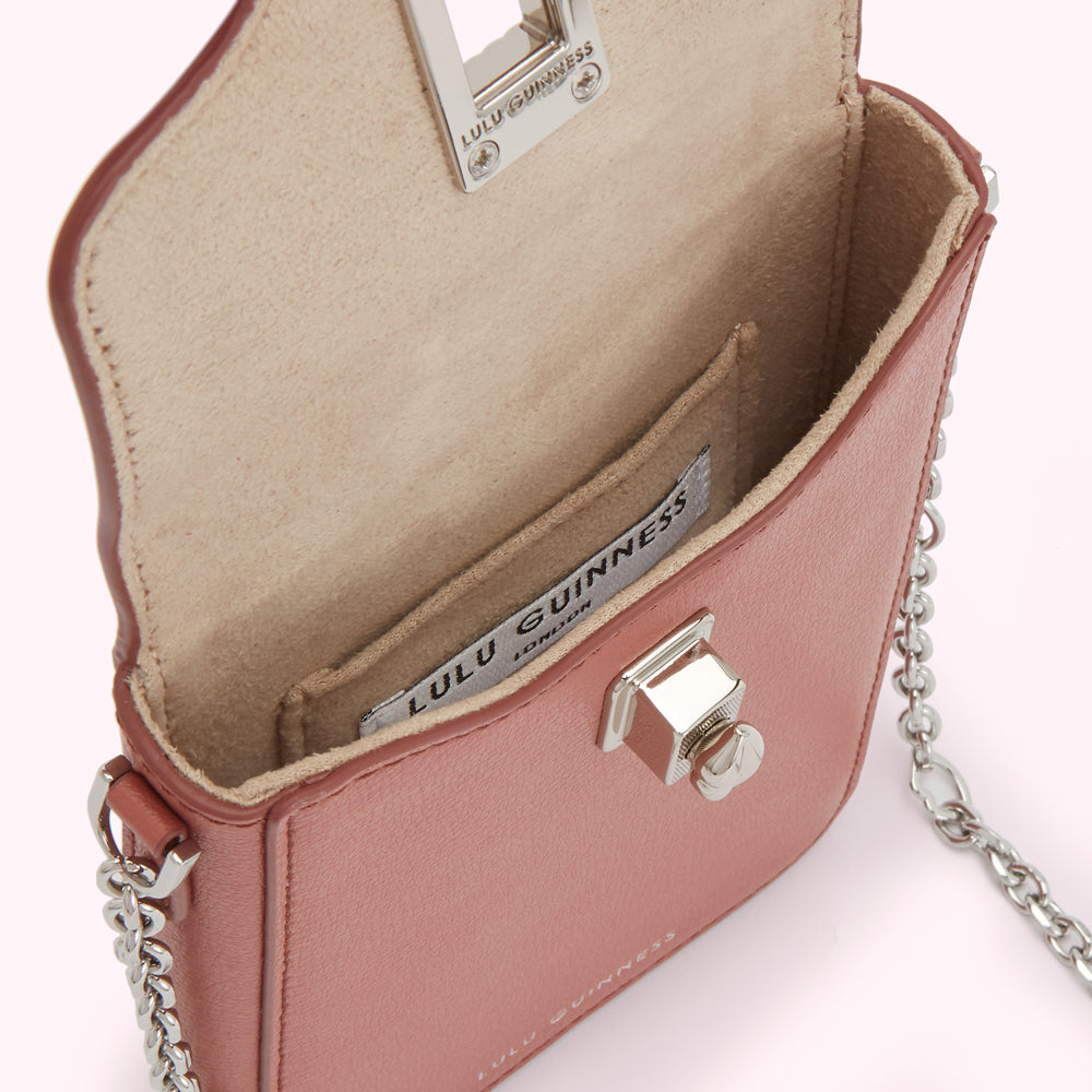 Dusty rose Lulu Guinness mini crossbody bag open to reveal beige interior and silver chain strap.
