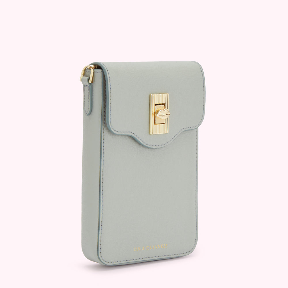 Light blue leather Lulu Guinness crossbody phone bag with gold clasp.
