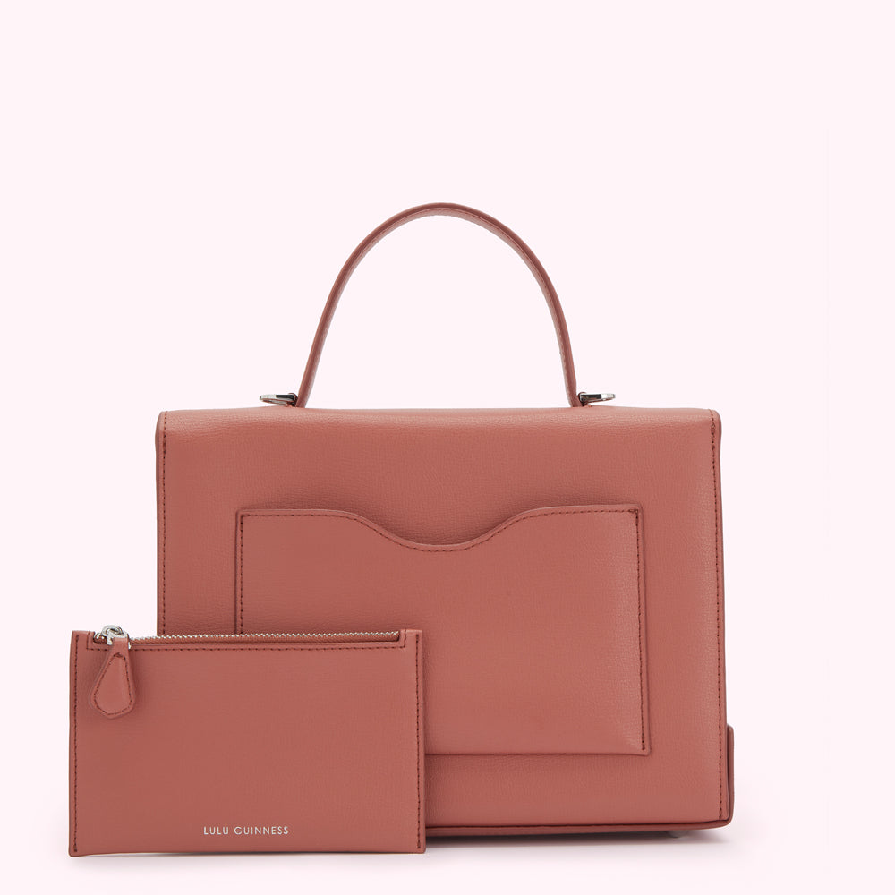 Dusty rose Lulu Guinness handbag and matching zip pouch against a white background.
