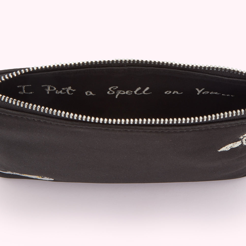 Black zip pouch with embroidered bees and the text "I Put a Spell on You" inside.