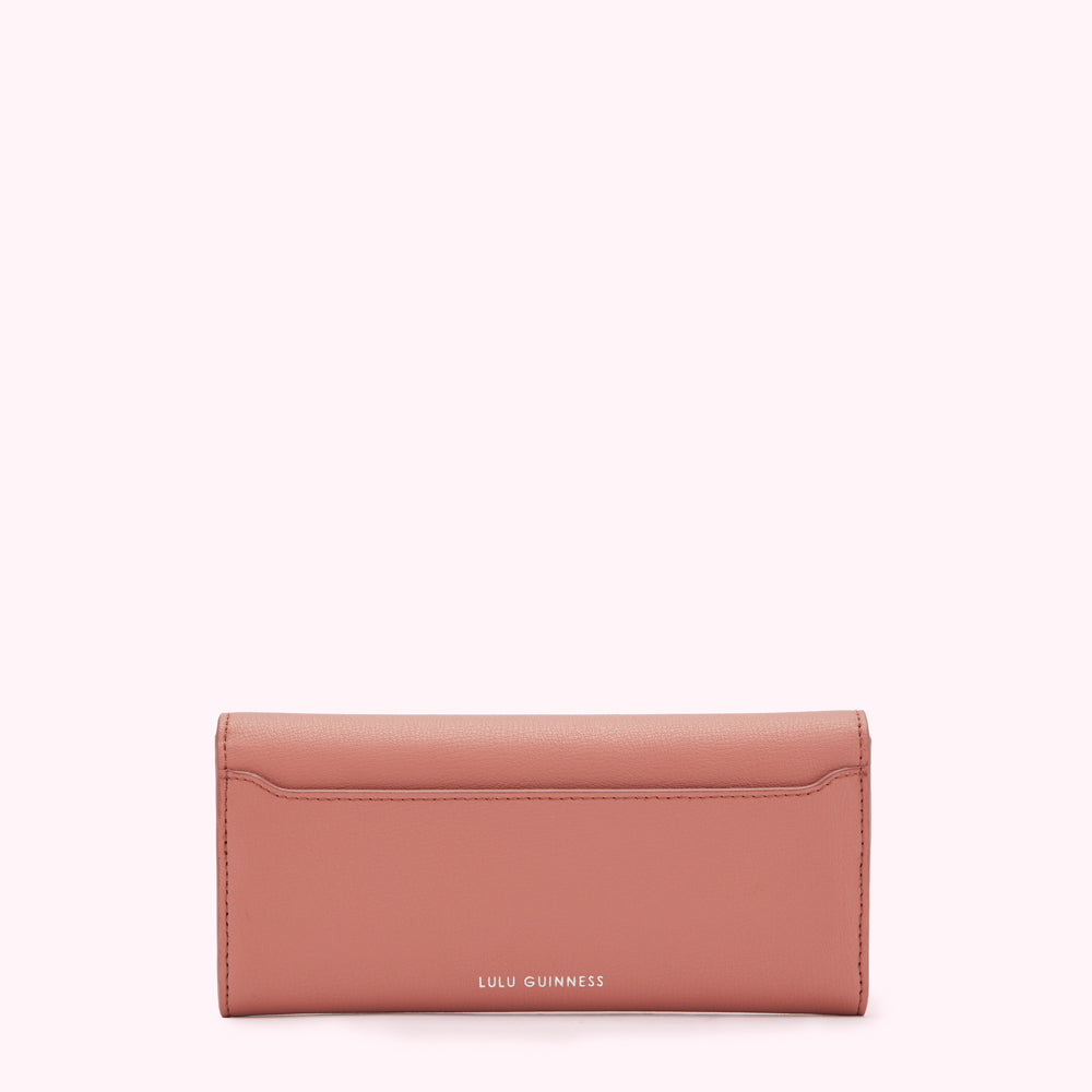 Dusty rose Lulu Guinness wallet on a white background.
