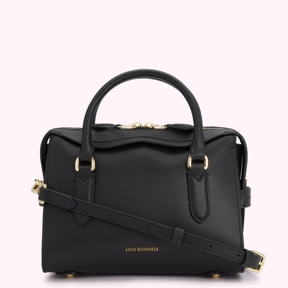 Black Lulu Guinness leather satchel with gold hardware and strap.