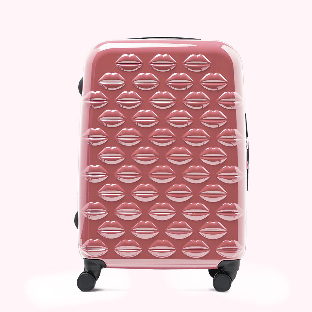 Pink suitcase covered in a pattern of lips.