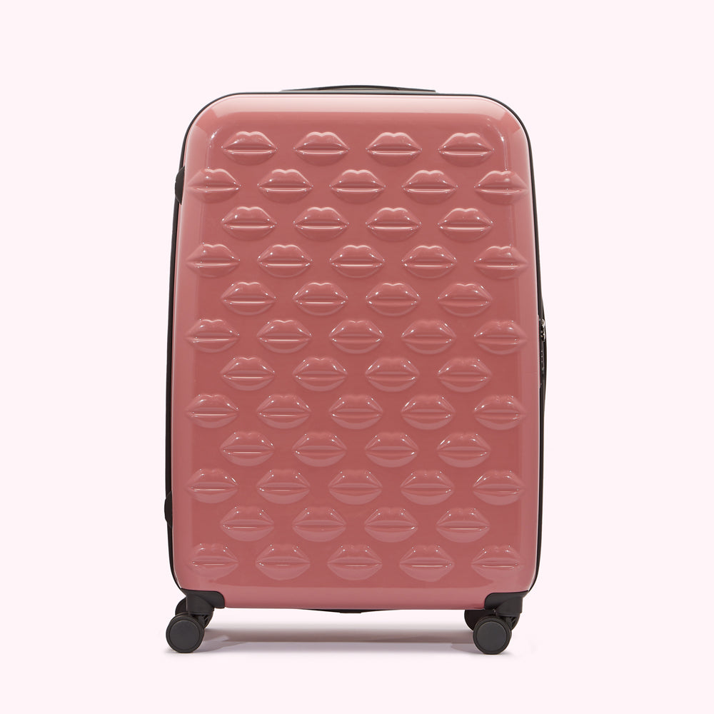 Pink suitcase with a lip print pattern.