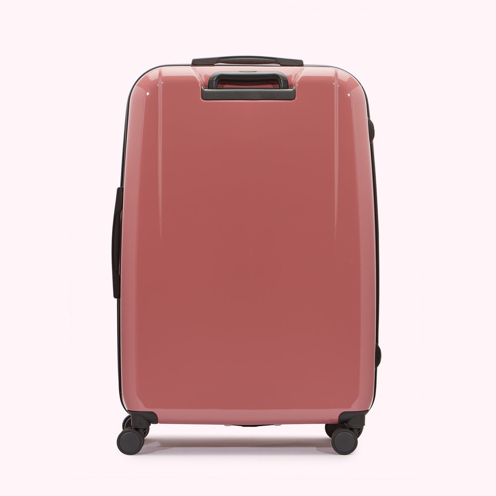 Pink suitcase on a white background.

