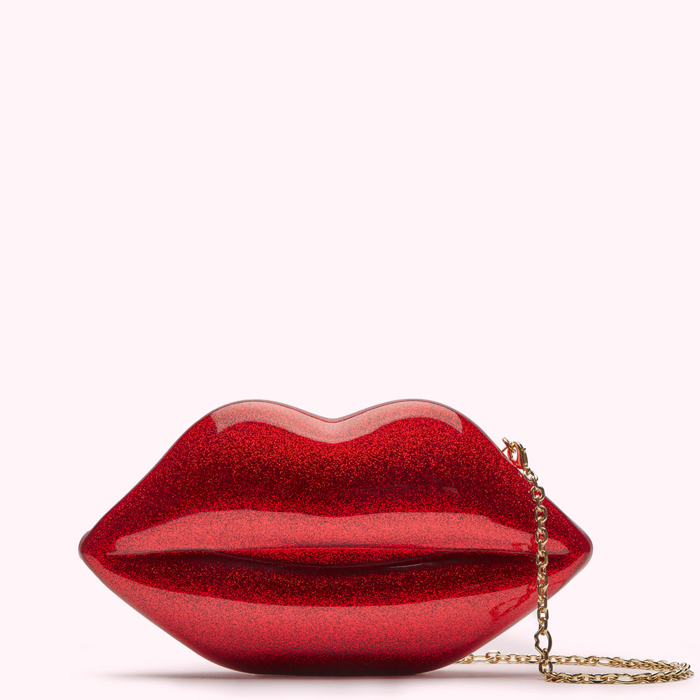 Red glitter lips shaped clutch with gold chain strap.
