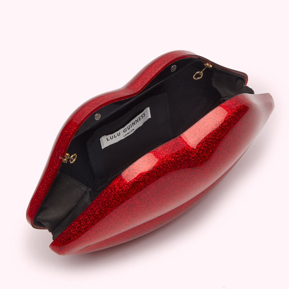 Open red glitter Lulu Guinness lip-shaped clutch.
