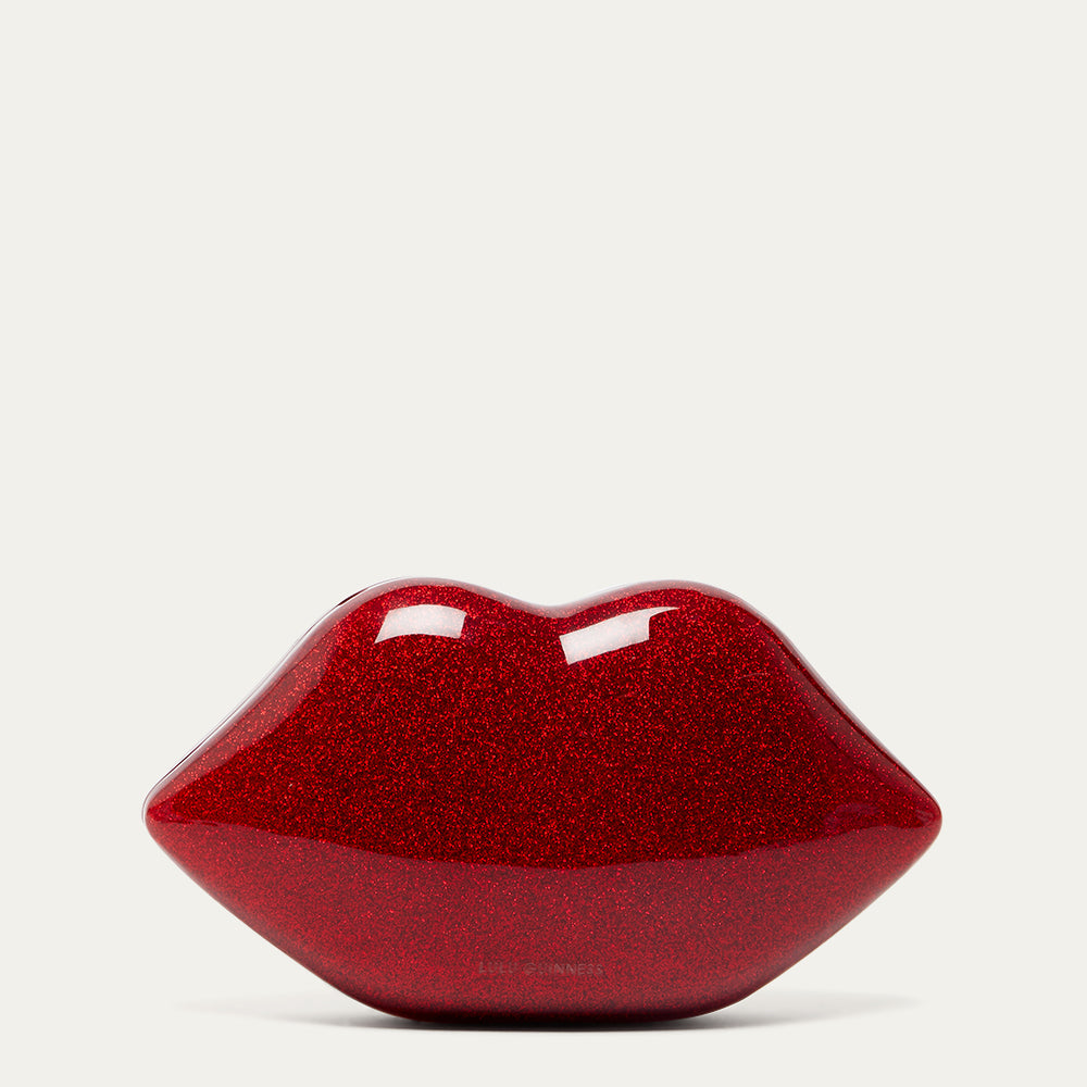 Red glittery lip-shaped clutch bag on a light grey background