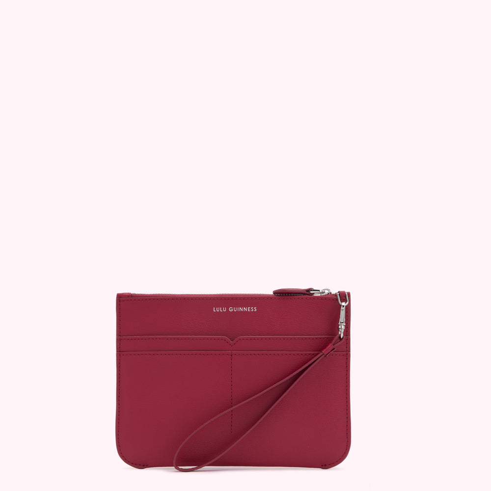Crimson red Lulu Guinness zip-around pouch with wrist strap.
