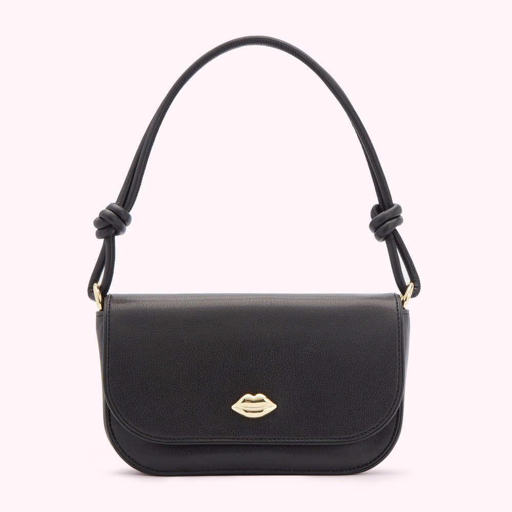 Black leather handbag with gold lip detail and knotted top handles.
