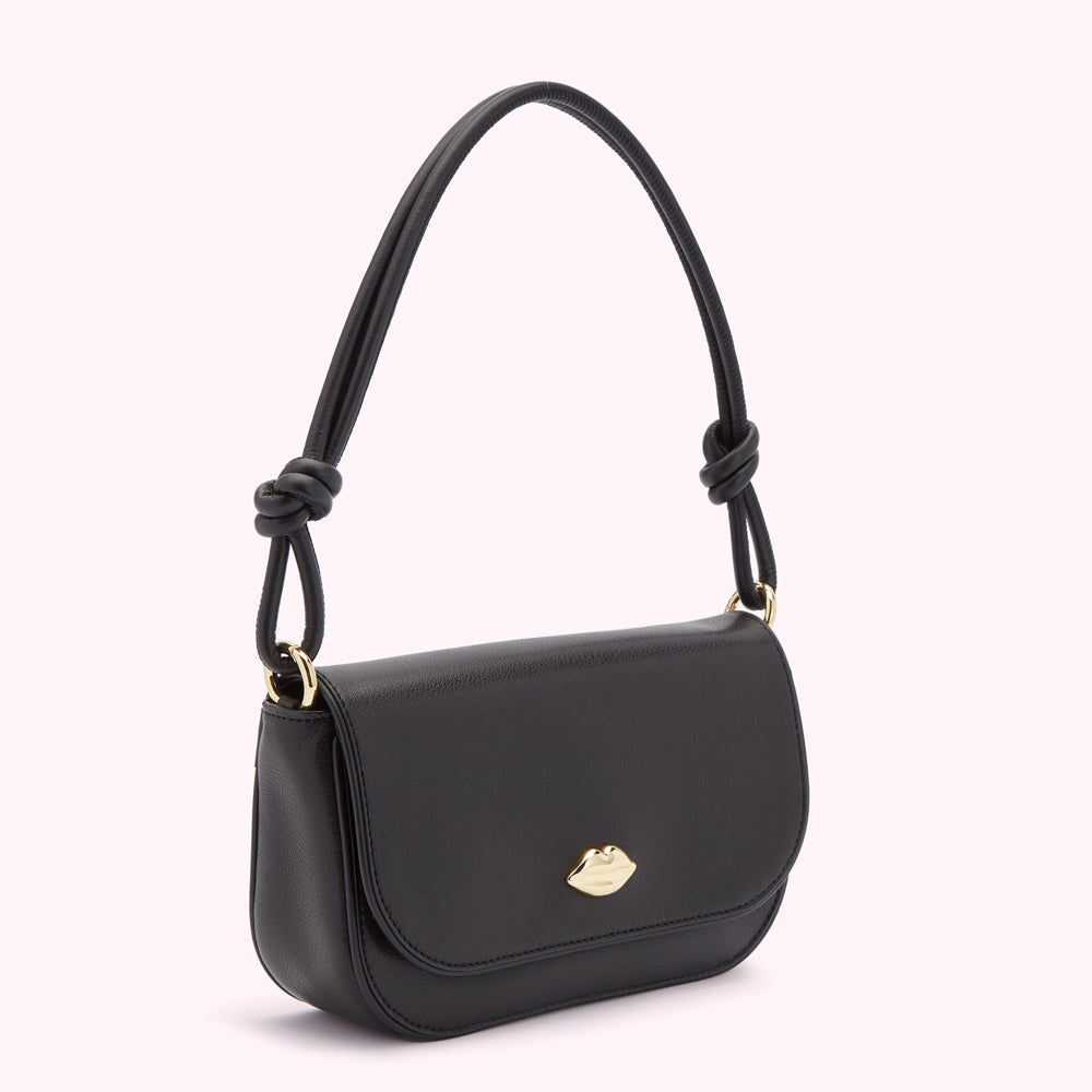 Black leather shoulder bag with gold lip detail and knotted straps.
