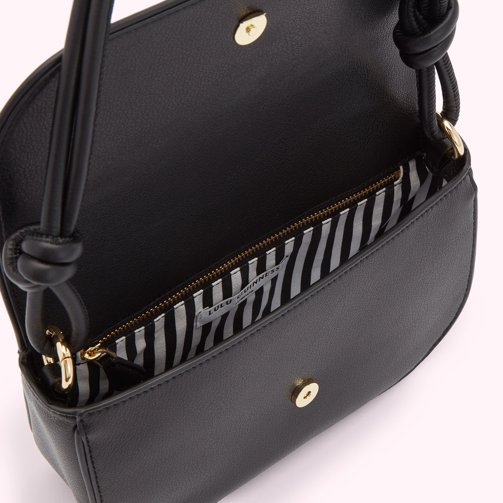 Black Lulu Guinness shoulder bag with knotted handles and black and white striped interior.
