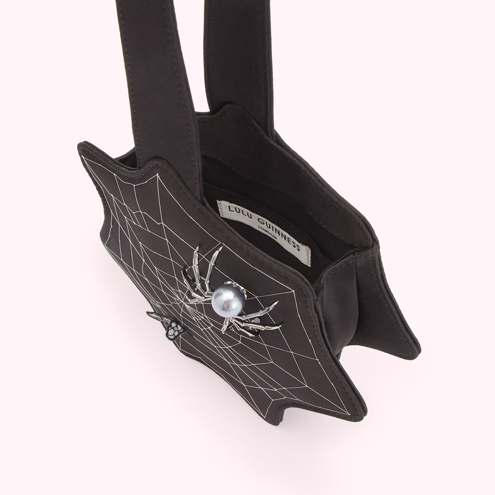 Black Lulu Guinness spiderweb handbag with silver spider and pearl detail.

