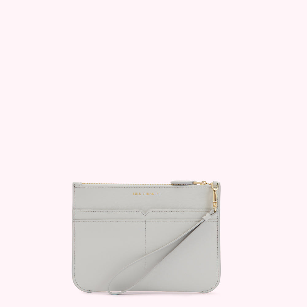 Light grey leather clutch with gold zipper and wrist strap. The brand name LULU GUINNESS is subtly embossed on the front.
