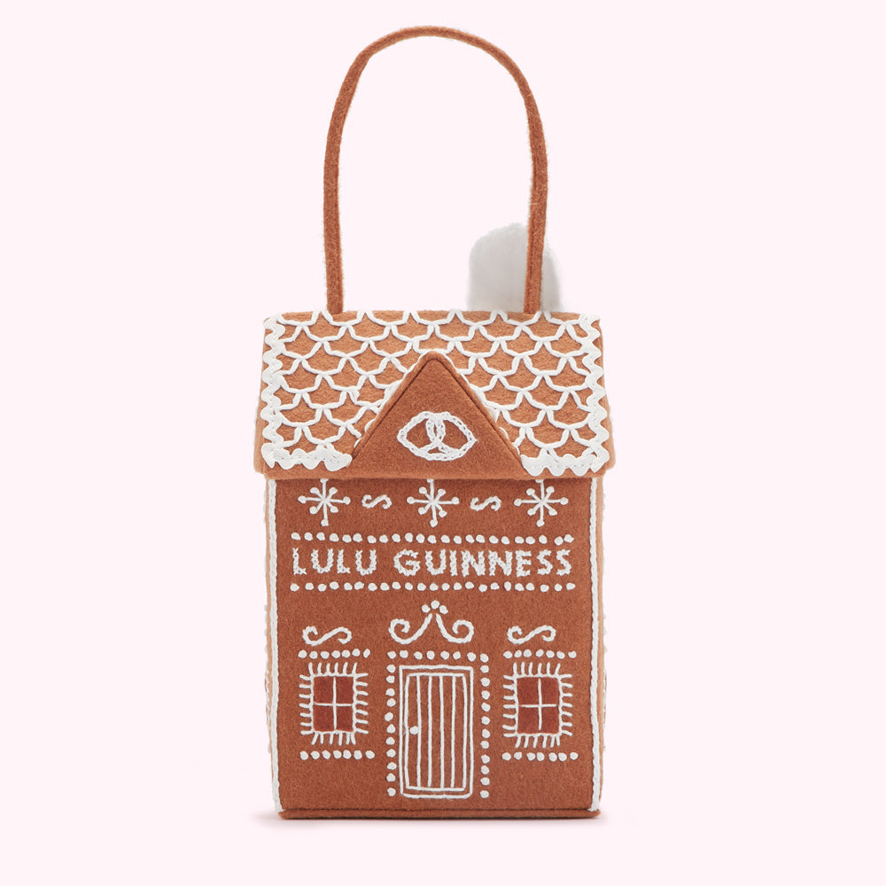Brown felt gingerbread house-shaped handbag with white embroidery.
