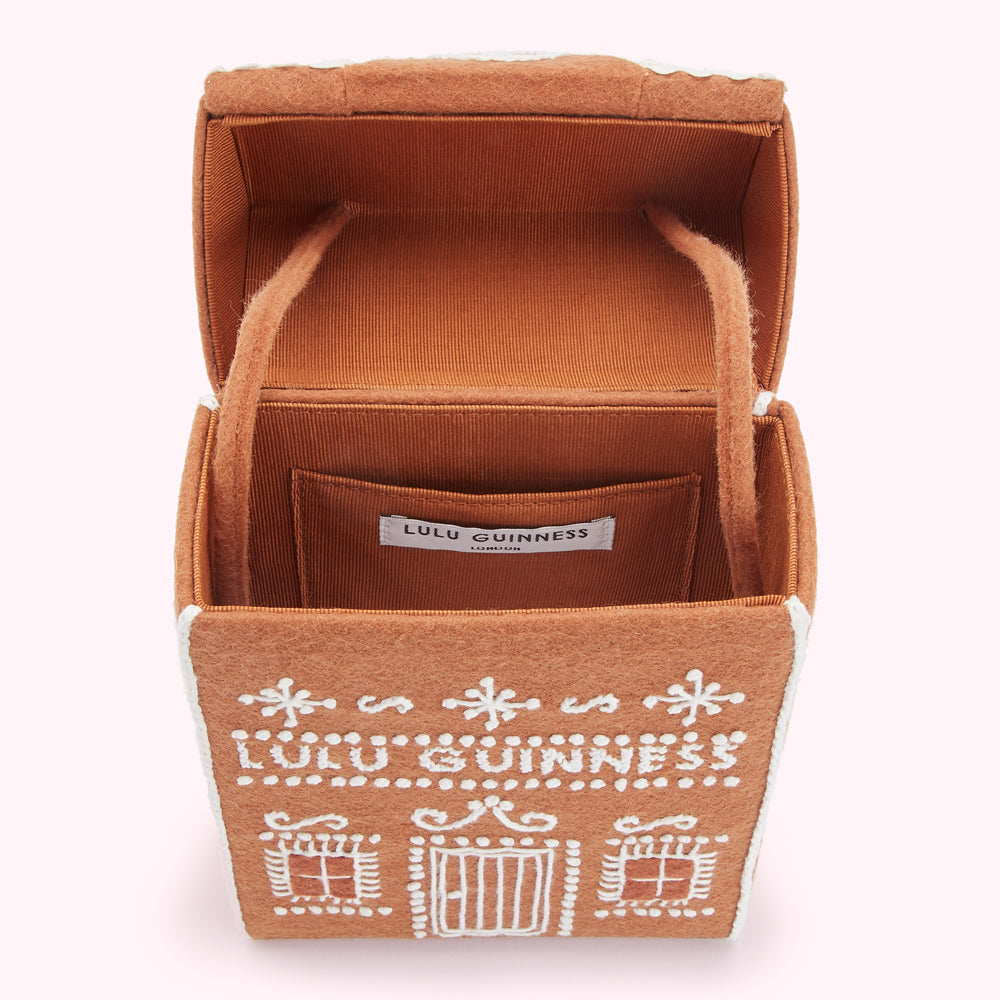 Open gingerbread house-shaped Lulu Guinness box bag, brown felt exterior with white embroidery, brown satin lining.