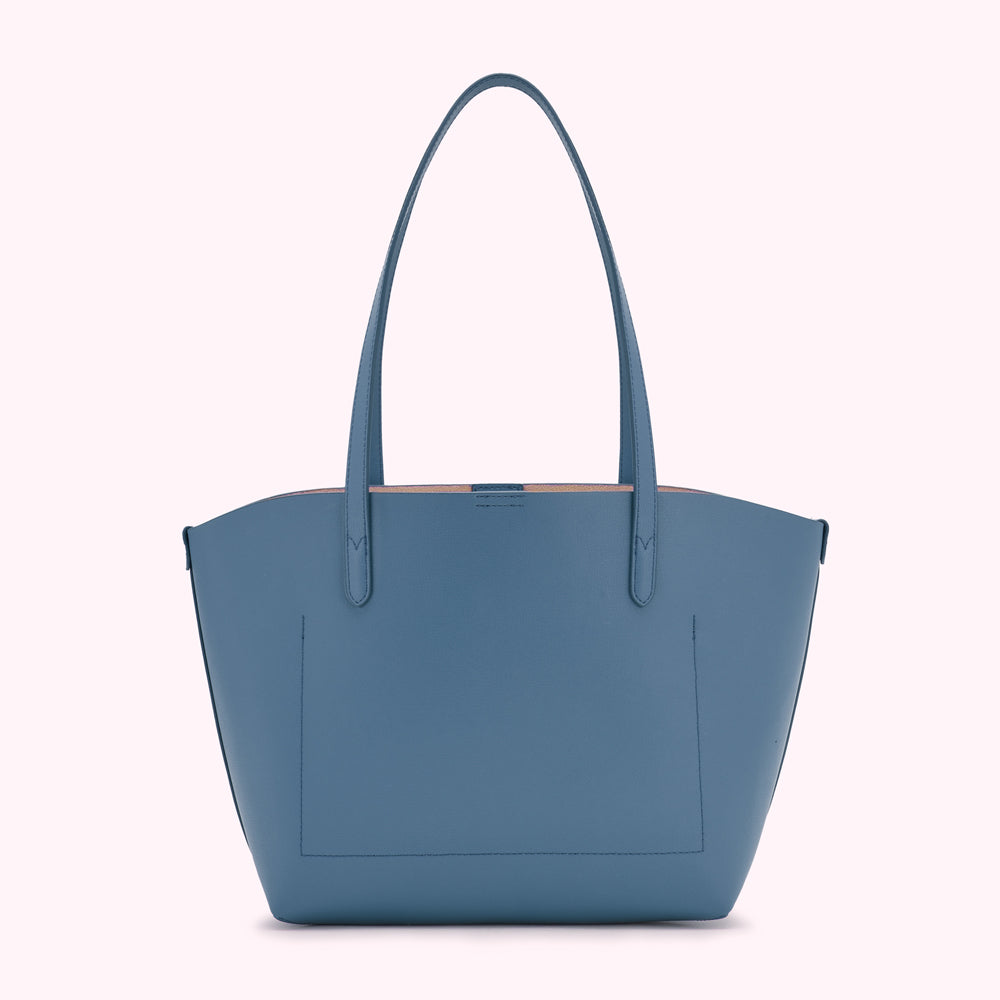 A blue leather tote bag on a white background.