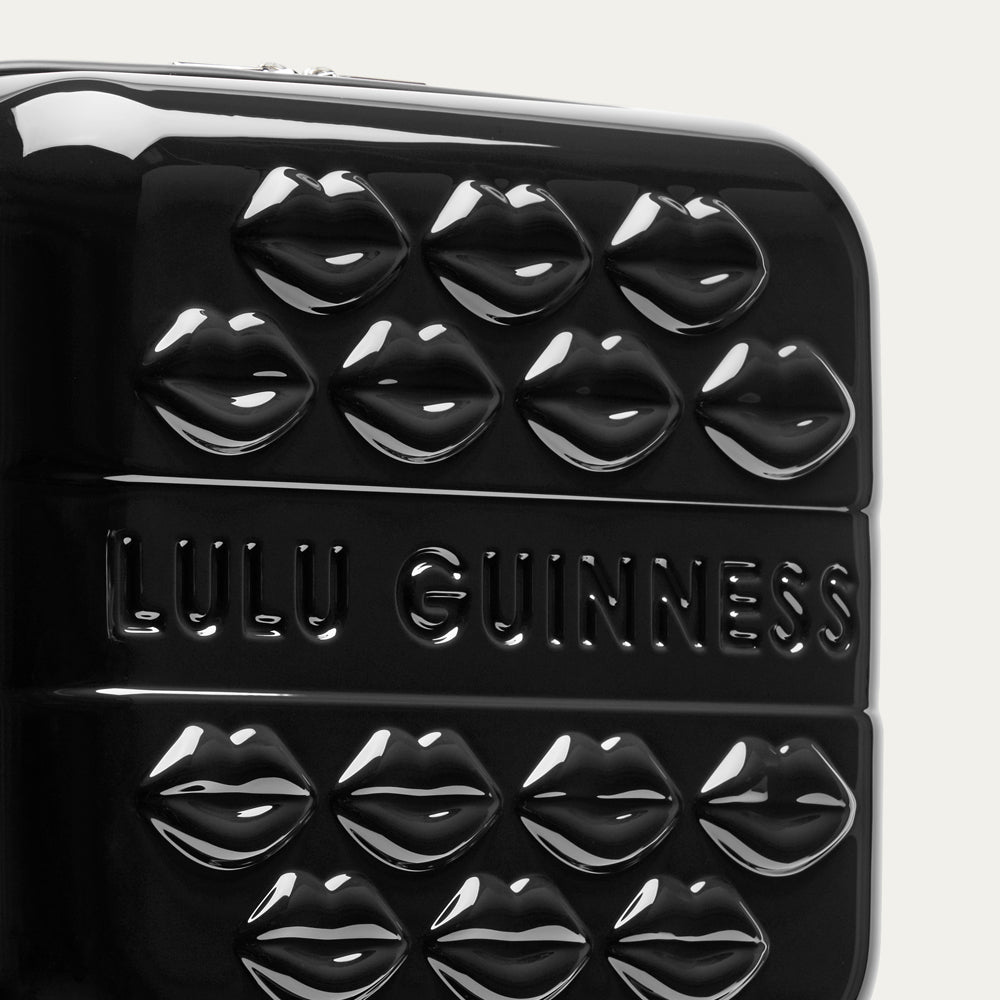 Black vanity case with lip-shaped design and 'Lulu Guinness' branding on a white background