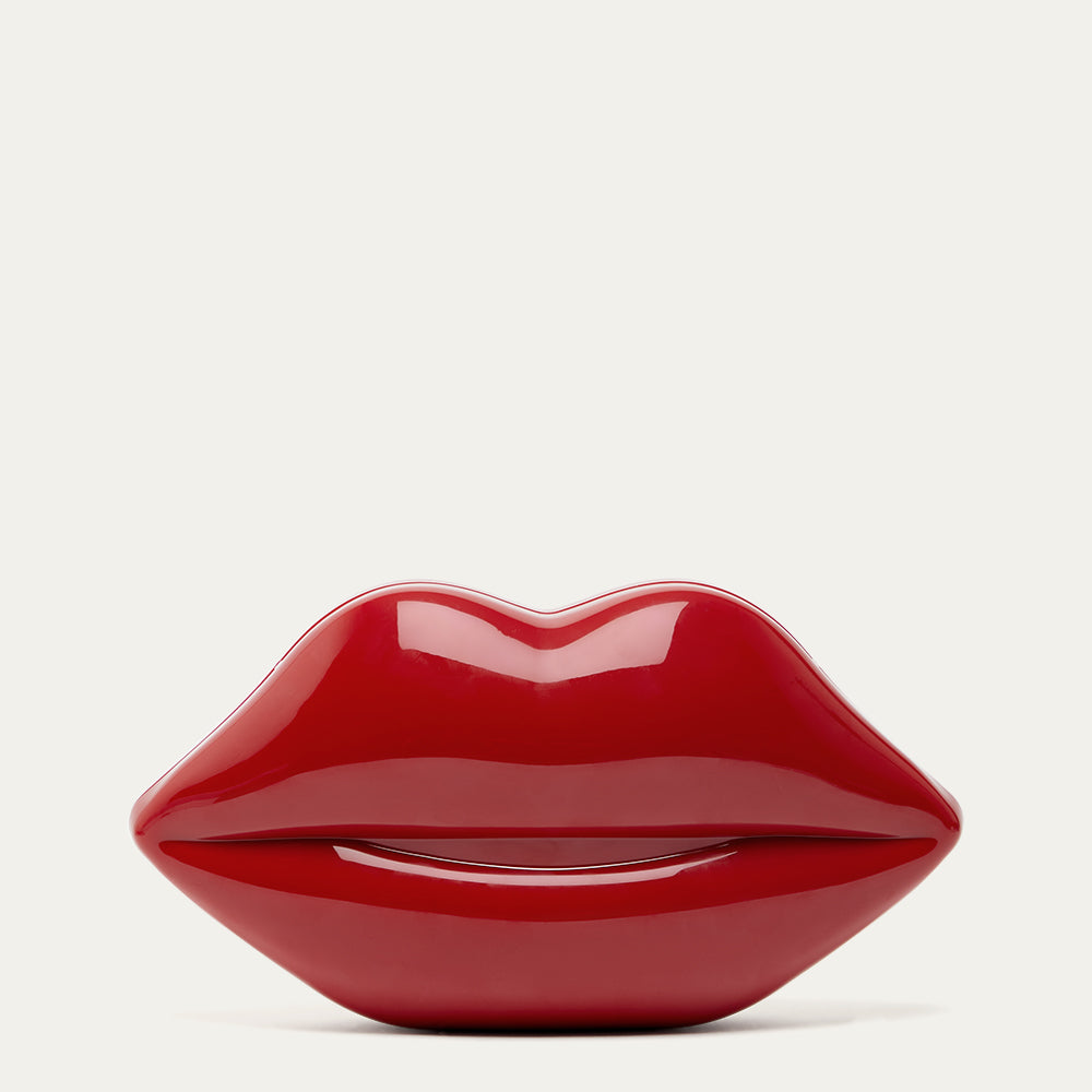 Red lip-shaped clutch on a light grey background