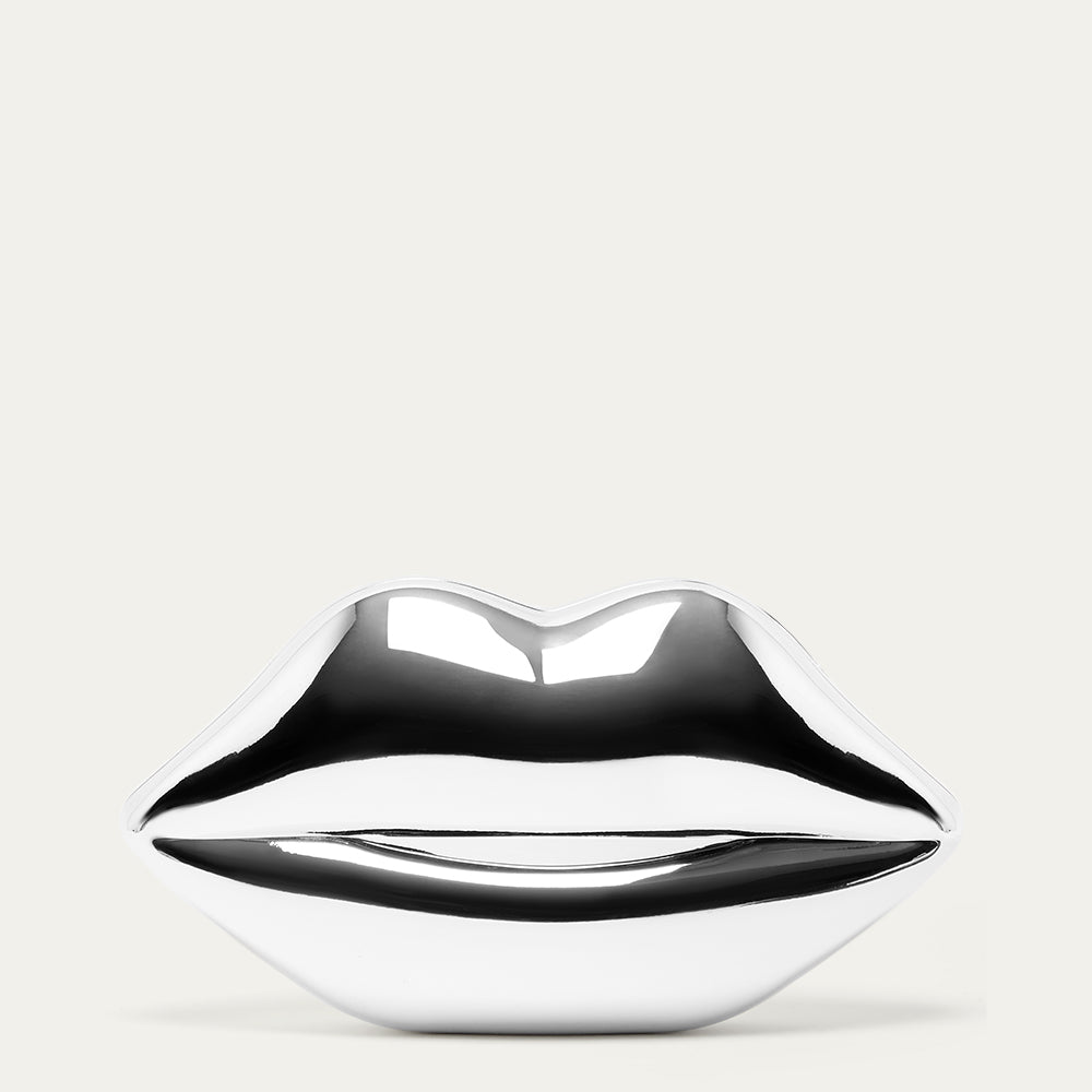 Metallic silver lip-shaped clutch bag on a light grey background