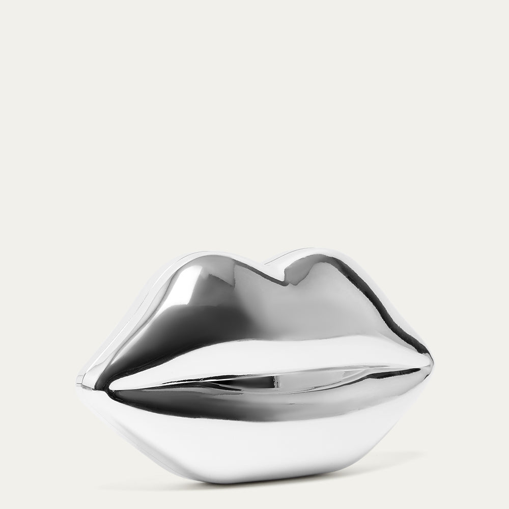 Metallic silver lip-shaped clutch bag on a light grey background