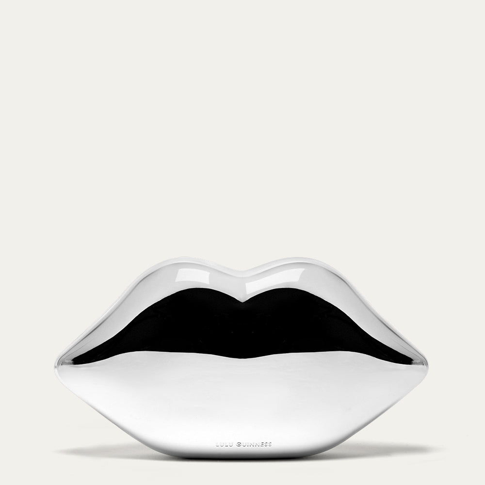 Silver lip-shaped clutch bag on a white background