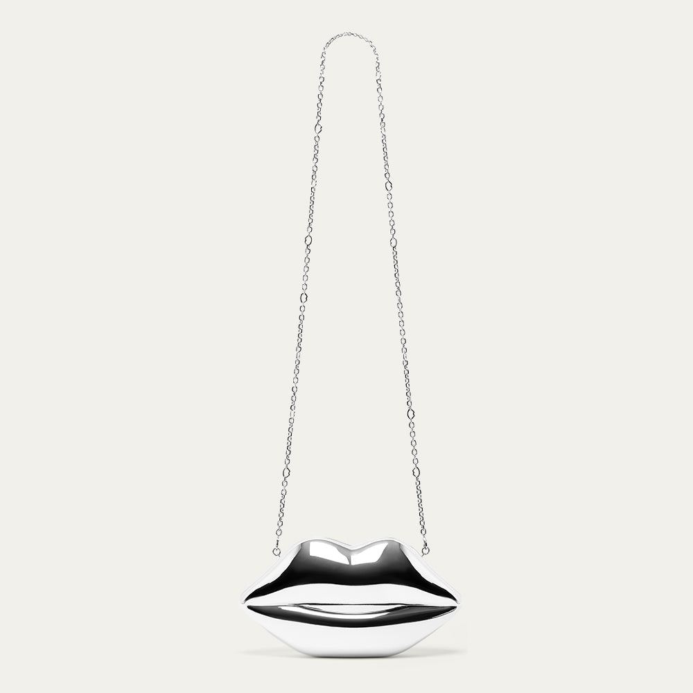 Silver lip-shaped clutch bag on a chain against a white background
