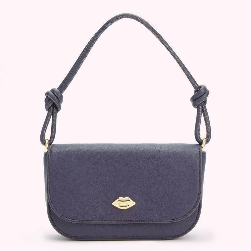 A dark grey shoulder bag with a knotted strap and a gold lip-shaped clasp.
