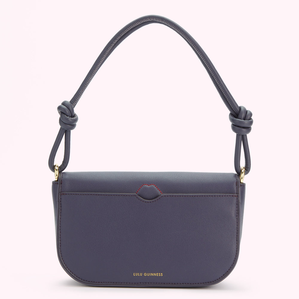 Dark-blue Lulu Guinness knotted shoulder bag against a white background.