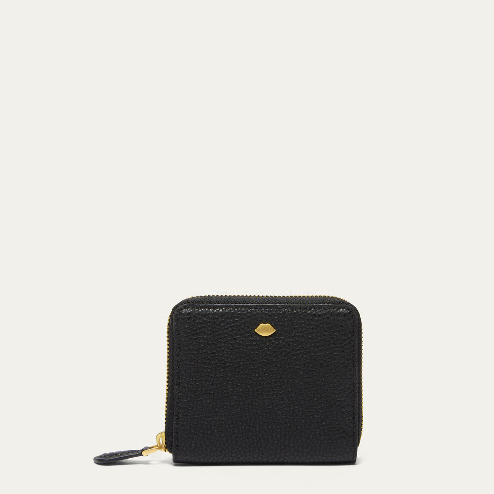 A small black pebbled leather zip-around wallet with gold-tone hardware and a small lip-shaped stud on the front, shown against a plain off-white background.
