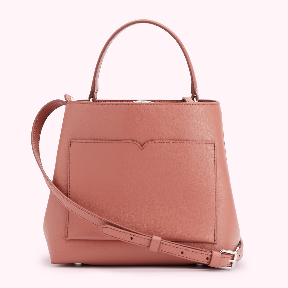 Dusty rose leather handbag with top handles and a detachable shoulder strap.

