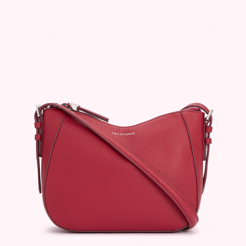 Red Lulu Guinness crossbody bag with silver hardware.
