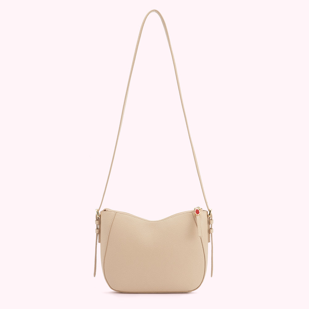 Beige crossbody bag with a curved bottom and long strap.
